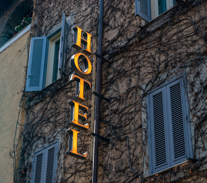 A hotel found in travel packages featuring a prominent sign displaying the word "Hotel" in clear, bold letters.